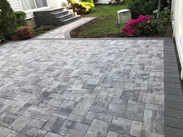 Large-format gray paver patio with charcoal border