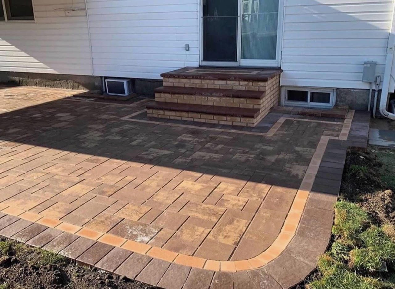 Rear paver patio with brick steps and landing